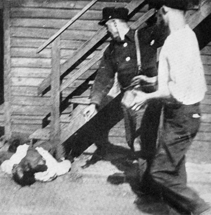 Riot in Chicago, July 1919. Two white men stoning an African American to death. Public Domain